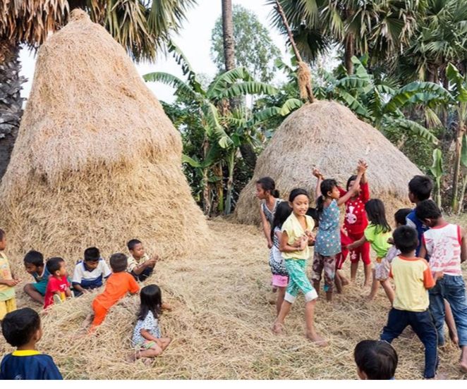 Hình ảnh trẻ em nô đùa bên cây rơm